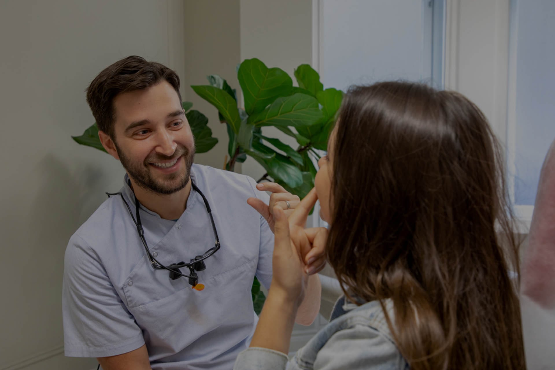 Adult woman pointing her teeth to dentist.