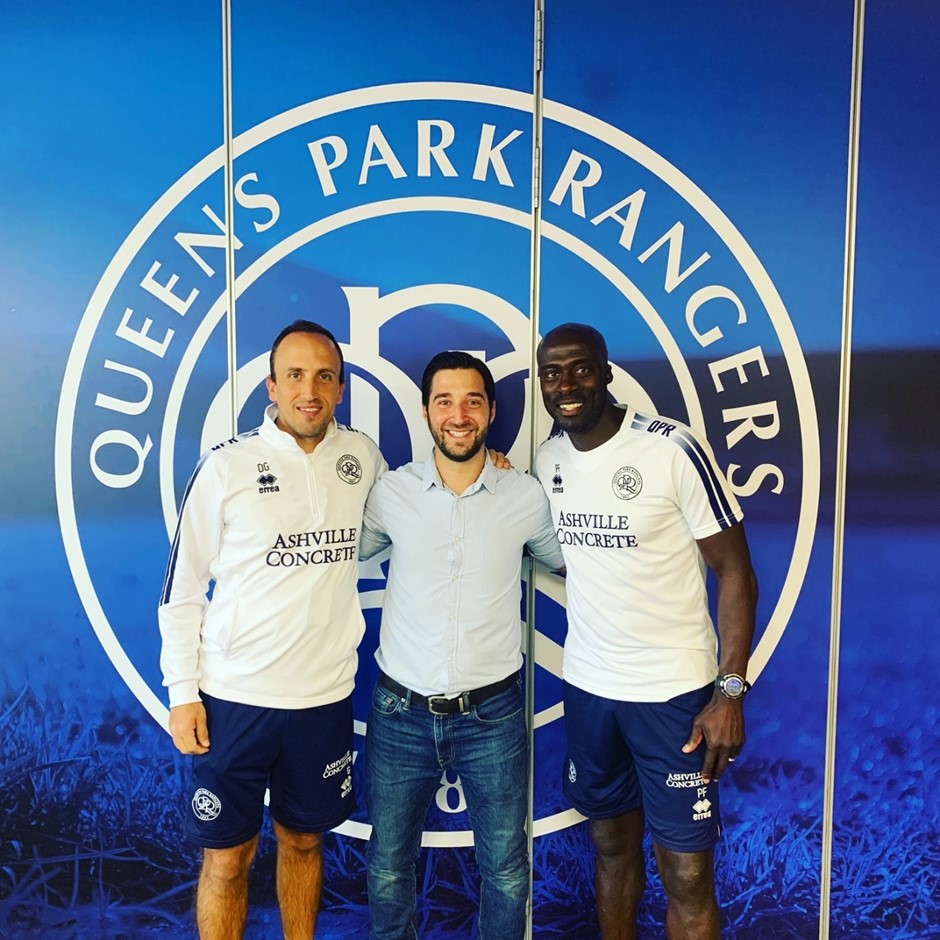 A dentist standing in the middle of two young footbal players - sport dentistry ideas